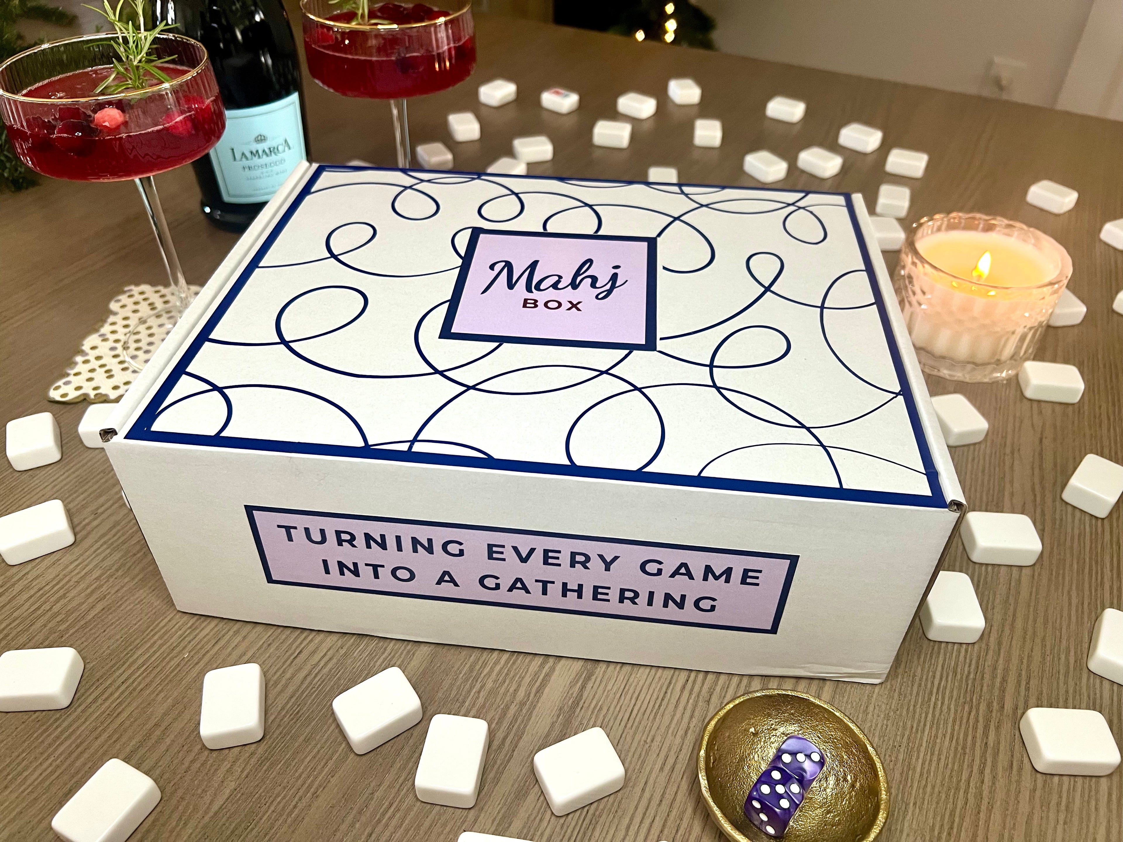 Mahjong box with dice and glasses on a table